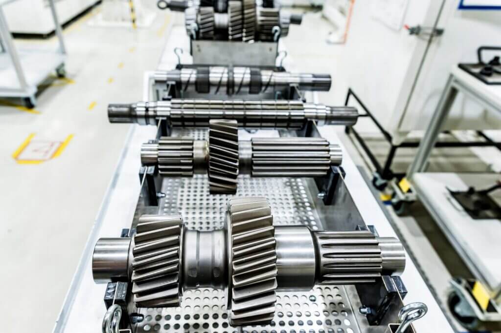 brand new gear shafts for tractor transmission on an assembly line in a factory